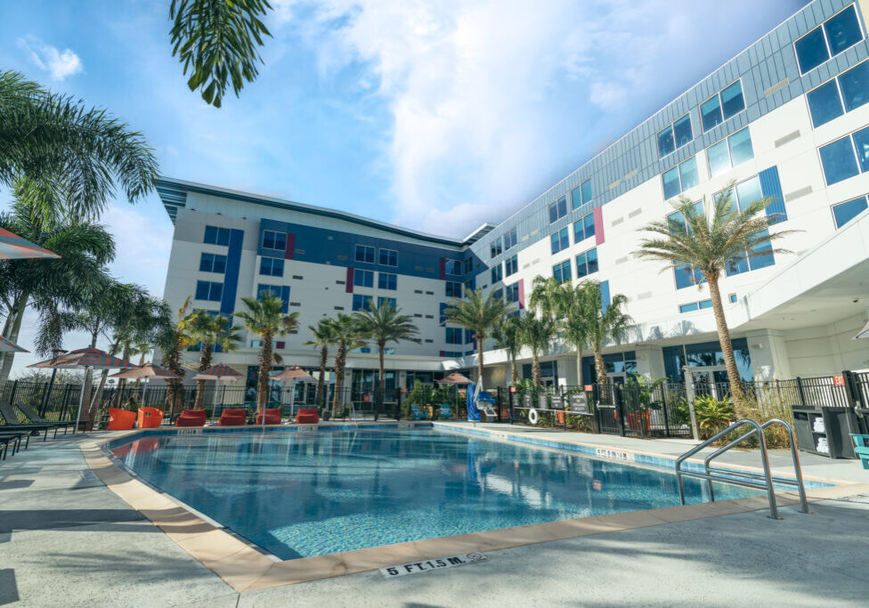 Pool next to hotel building